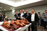 Roast pig-cutting ceremony: (from right) Prof. Kung Hsiangfu; Prof. Chan Wai-Yee; Prof. Michael S.C. Tam; Prof. Cho Chi-Hin; and Prof. Woody W.Y. Chan